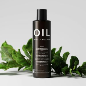 a bottle of oil sitting next to a plant